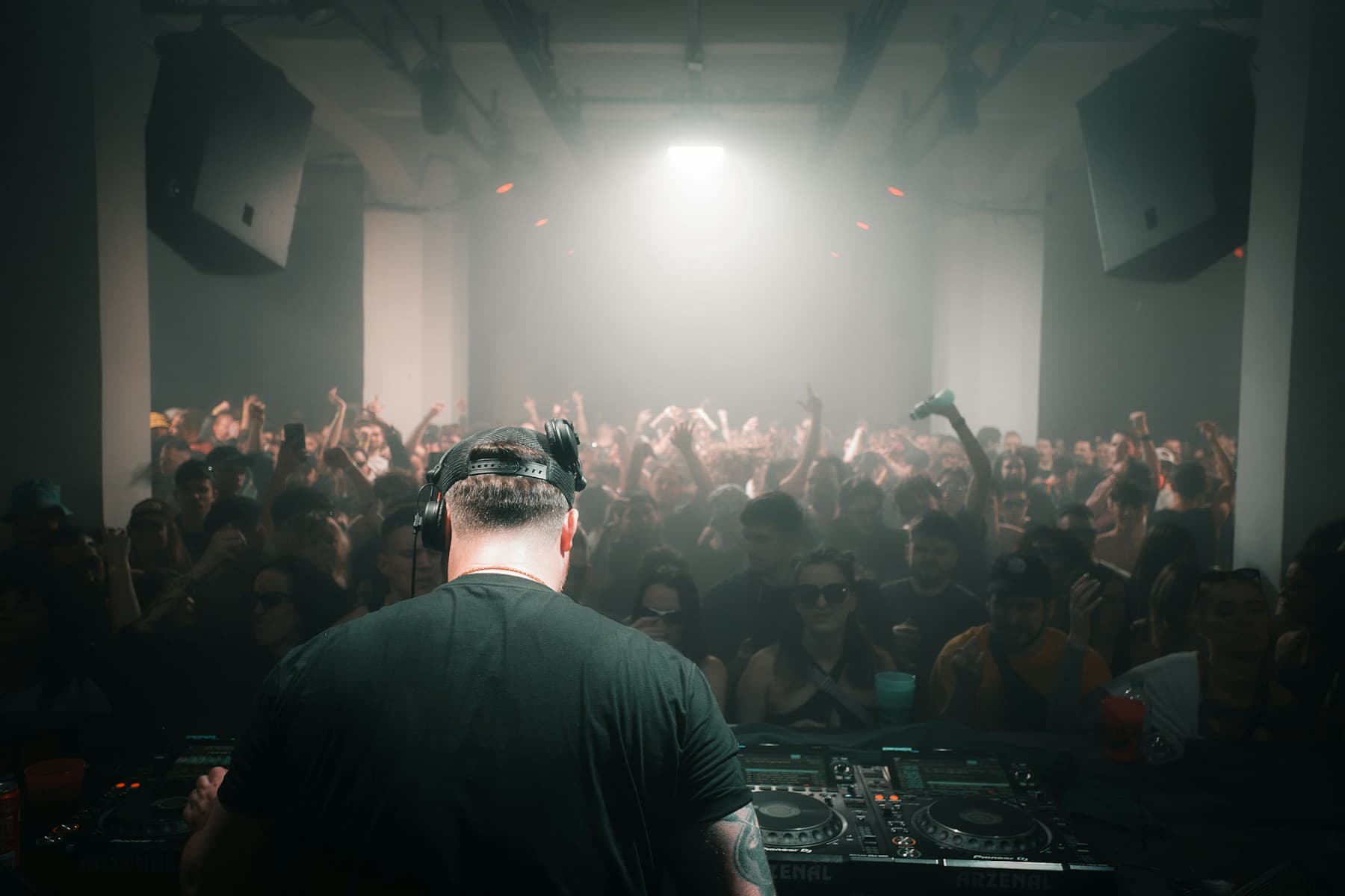A DJ performing for a crowd in a nightclub