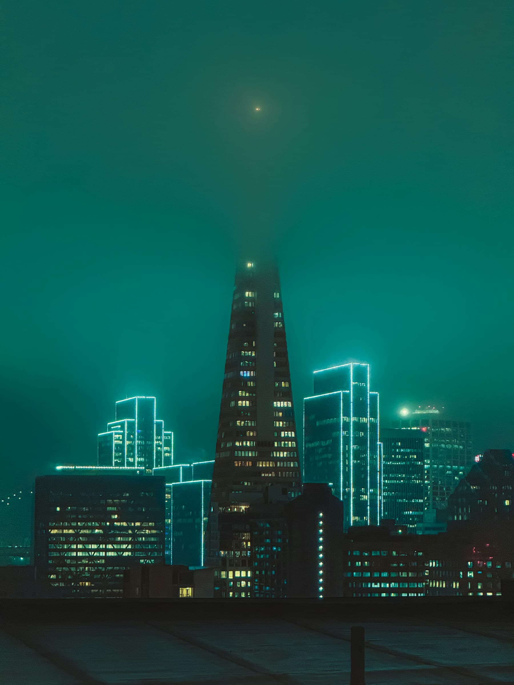 A view across the city at night from a rooftop