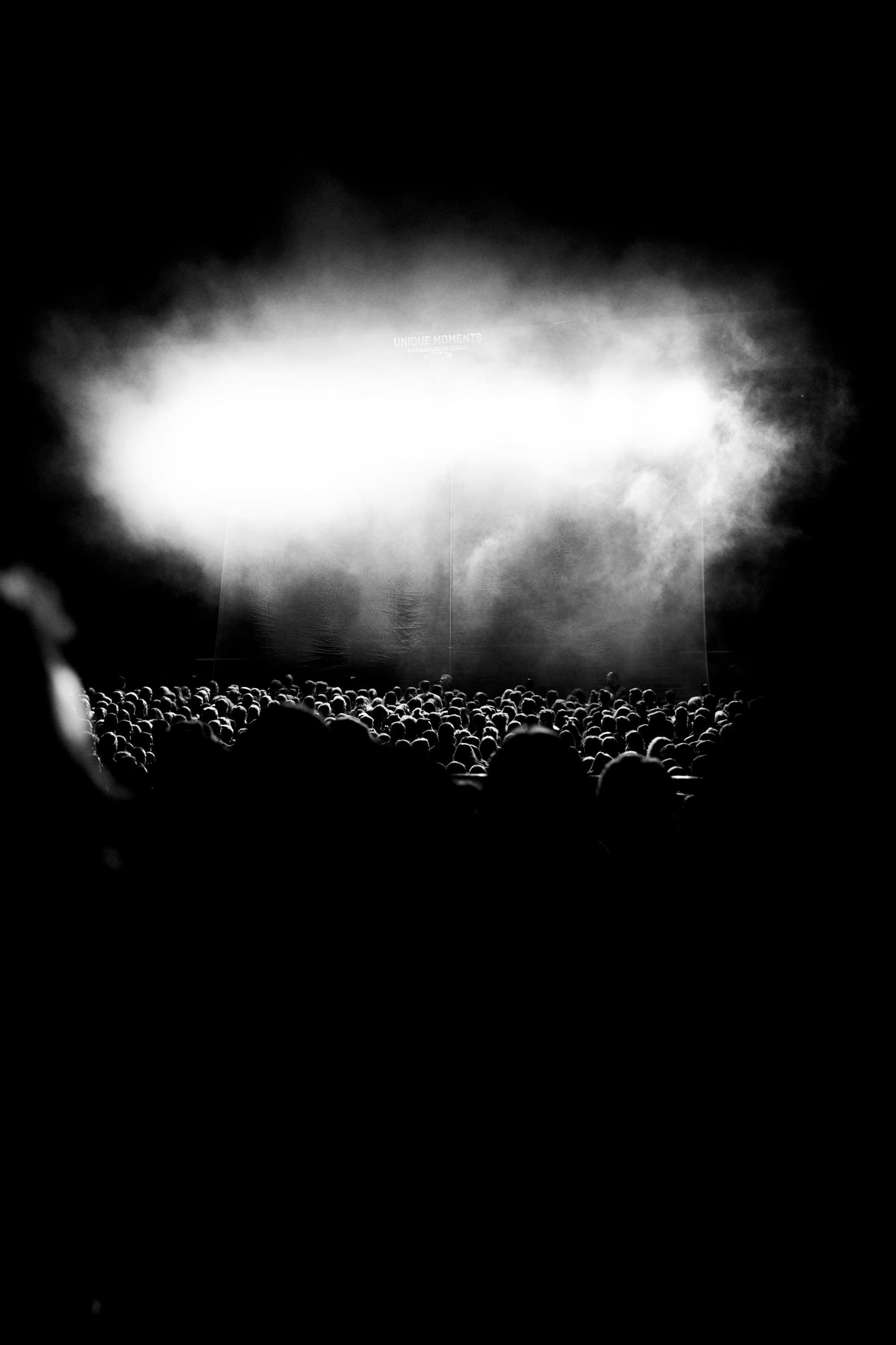 Smoke lit from behind in a dark room